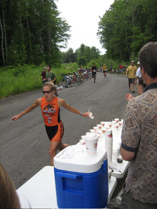 A Competitor Grabs Water At The Start Of The Run