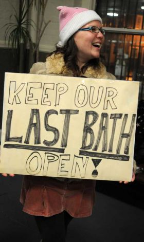 Elisabeth Mason ), originally from Albany, now lives in Maryland, holds a sigh as South End residents rally to save Public Bath No. 2 in Albany, NY on November 8, 2010. The public bath is slated for closure under Mayor Jerry Jennings proposed 2011 budget. (Lori Van Buren / Times Union)