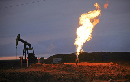 Bakken Oil Field In North Dakota, Rig And Flare Burning Off Natural Gas