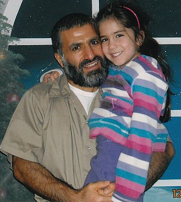 Yassin Aref holds his youngest daughter on a rare prison visit.