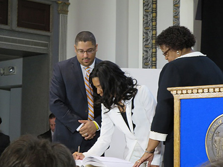 Dorcey Applyrs (1sr Ward) Signs The Book, City Clerk Nala Woodard And Carolyn McLaughlin Preside