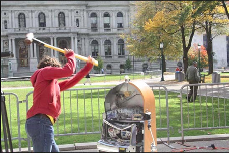 The Right Idea: Bill Sisk Of The Rockefeller Institute Smashes A Slot Machine In Front Of The State Capitol, October 2013. The Corporate Media Did Not Report This Demonstration