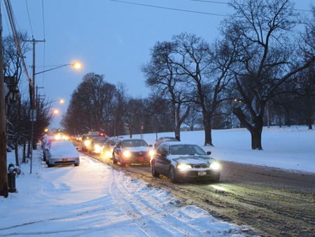 Cars At A Traffic Light On Morton Avenue, January Snow At Dawn