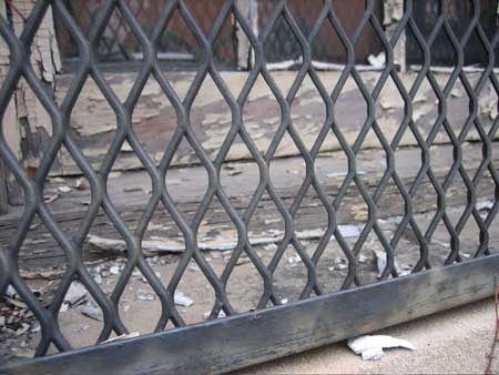 Piles of detached glazing spilled through the grates