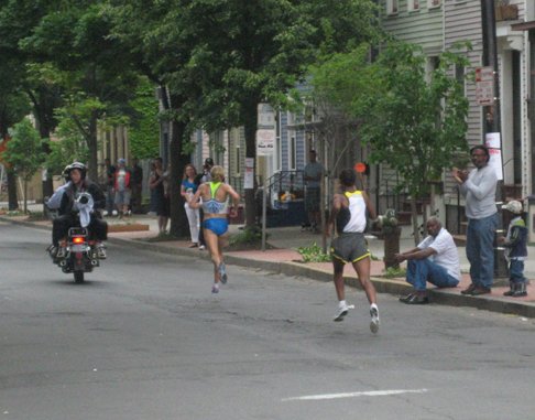 Note How The Runner In Front Is Trying To Pass The Motorcycle