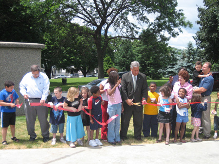 Dominick (at left) Demonstrates that He Can Cut Ribbons As Well As The Mayor (in suit)  (Click on photo for full size)