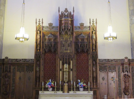 The Carved Wooden Cross Behind The Altar
