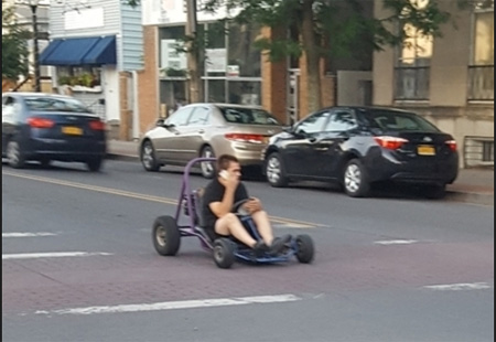 Kid with An Unlicensed Go-Cart (Talking On A Phone!) Photographed On Delaware Avenue At Marinello Terrace, July 2018